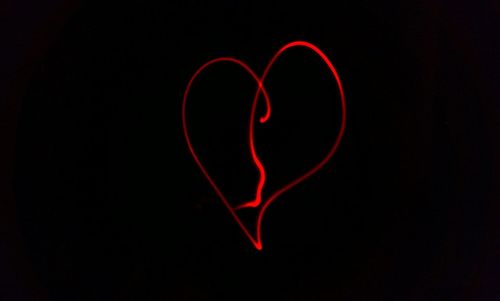 Close-up of heart shape over black background