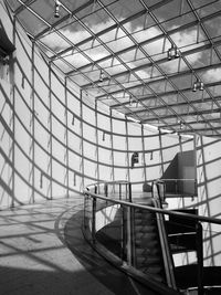 Low angle view of man walking on staircase in building