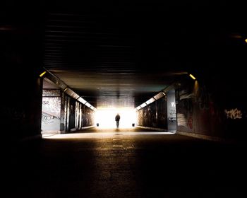 Man in illuminated tunnel