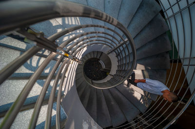 High angle view of man working on spiral staircase