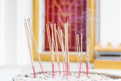 Close-up of burning incense sticks at temple