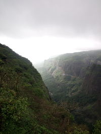 Scenic view of mountains against cloudy sky