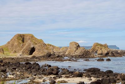 Rocks on beach against sky