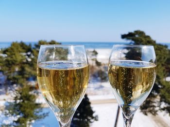 Close-up of wine in glass on table against clear sky