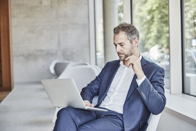 Businesssman sitting using laptop