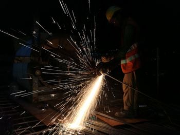 Low angle view of firework display at night