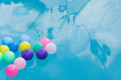 High angle view of multi colored balloons in swimming pool