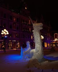 Illuminated building in city during winter