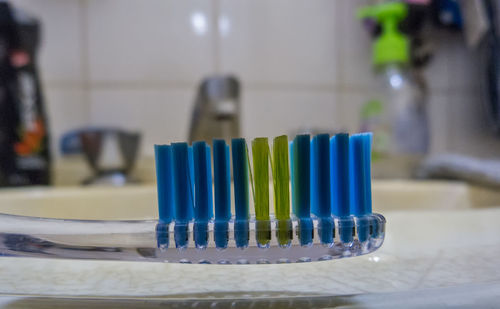 Close-up of toothbrush on table in bathroom