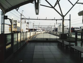 Empty railroad station platform against sky