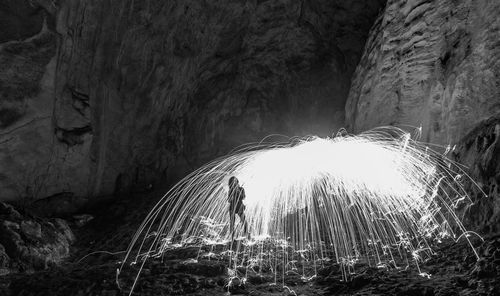 Illuminated cave at night