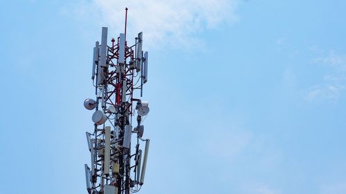 Low angle view of communications tower against sky