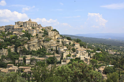 High angle view of town against cloudy sky