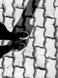 Low section of person standing on footpath