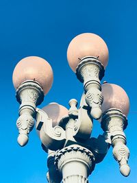 Low angle view of communications tower against blue sky