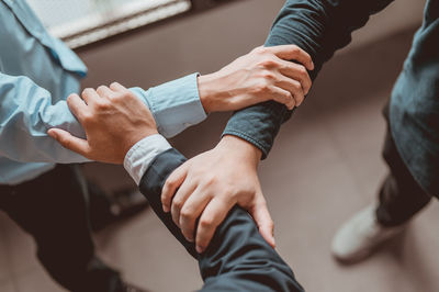 Midsection of couple holding hands