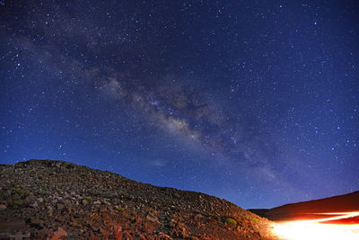 Scenic view of mountains against star field at night