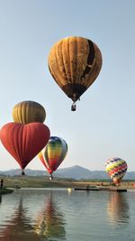 Hot air balloons flying against clear sky