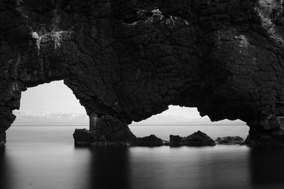 Scenic view of sea seen through cave