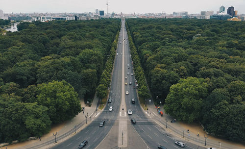 High angle view of highway amidst trees in city