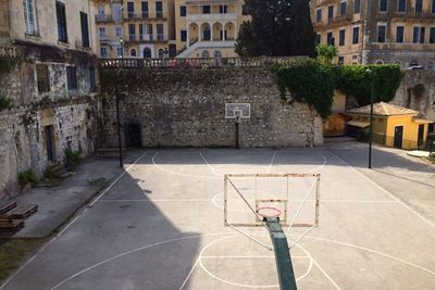 View of empty outdoor basketball court with buildings