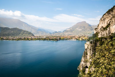 Scenic view of lake by mountains against sky