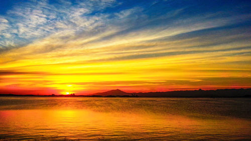 Scenic view of sea against romantic sky at sunset