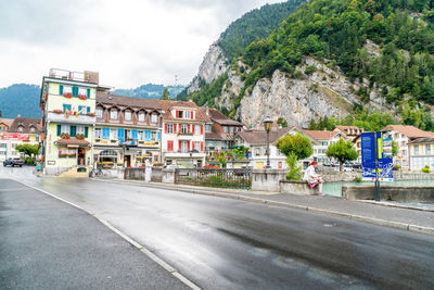 People on road against buildings