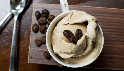 Close-up of ice cream with roasted coffee beans on table