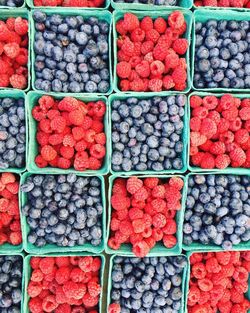 High angle view of multi colored berries for sale in market