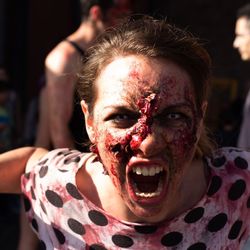 Close-up portrait of woman with injured face screaming outdoors