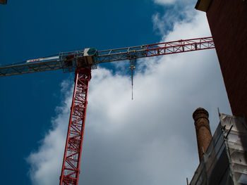 Low angle view of crane against sky