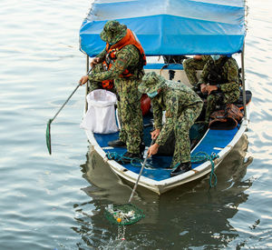 Rear view of man fishing boat in sea