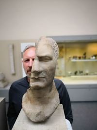 Mid adult man holding statue
