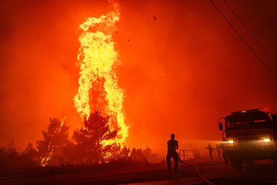 Group of people standing by bonfire