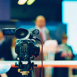 Close-up of video camera against people