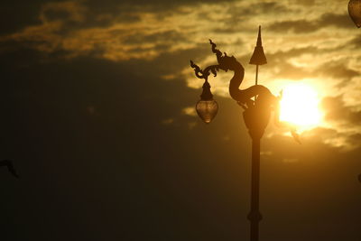 Low angle view of street light against sky during sunset
