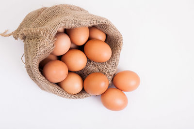 Close-up of eggs against white background