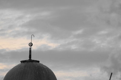 Low angle view of cross against sky