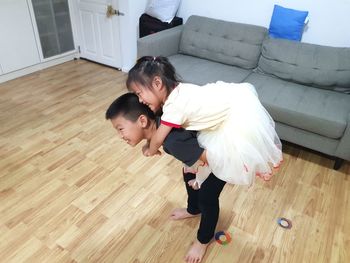 High angle view of father and son on floor at home