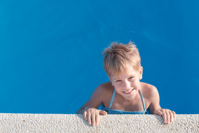 Portrait of happy boy in swimming pool