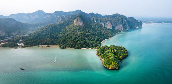 Scenic view of sea and mountains against sky