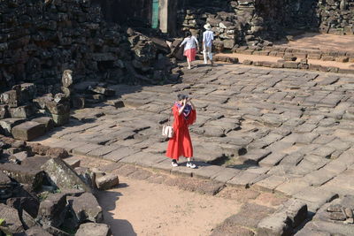 Rear view of people walking in temple