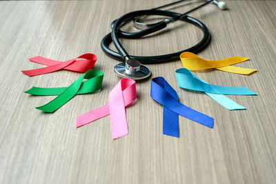 Multi colored ribbons with stethoscope on table