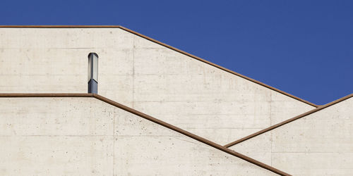 Low angle view of building against clear blue sky