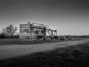 Abandoned structure on field against clear sky