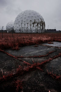 View of abandoned building against cloudy sky