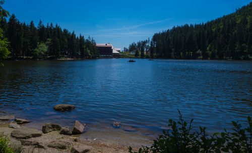 Scenic view of lake against blue sky