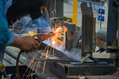 Man working on metal structure in factory