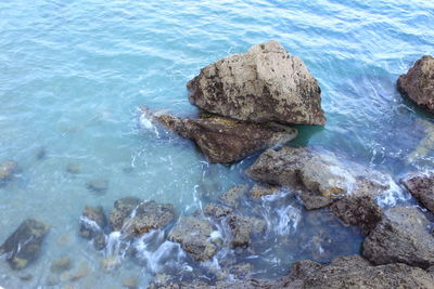 High angle view of rocks in sea against sky